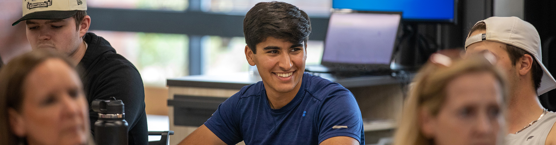 student smiling in a classroom