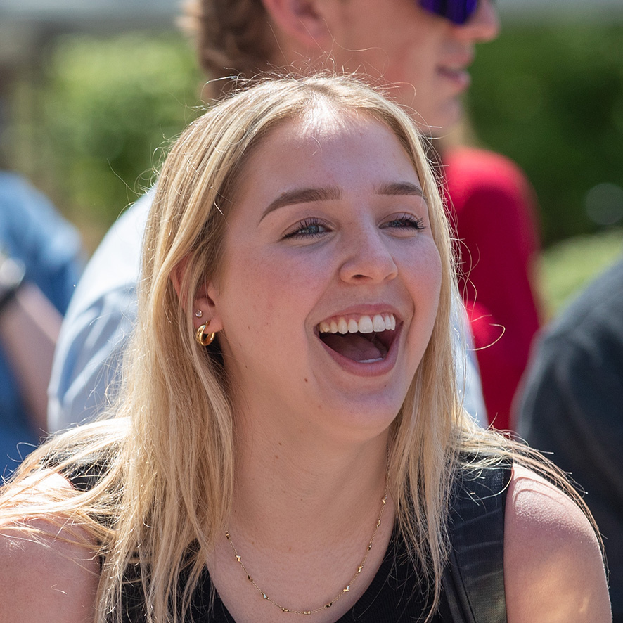 Student laughing outdoors